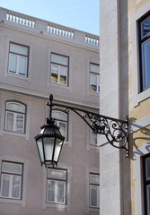 Fototapeta na wymiar Old lantern hanging on the street of historical center of Lisbon