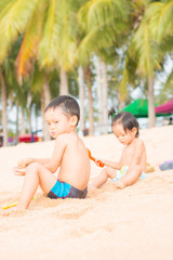 Fototapeta na wymiar Children playing on beach