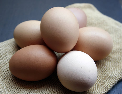 chicken eggs on brown burlap