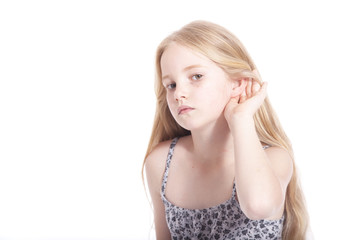 young girl making hearing gesture in studio