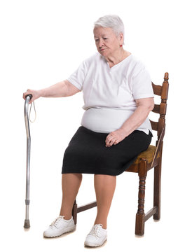 Old woman sitting  with a cane