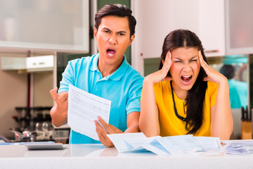 Asian couple fighting unpaid bills