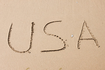USA, written on a sandy beach