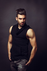 Fototapeta premium Handsome man posing in studio on dark background