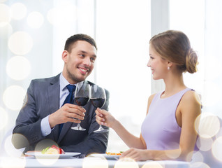 couple with main course and red wine at restaurant