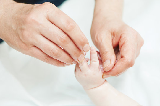 Masseur massaging a child hand