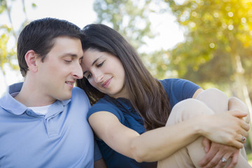 Fototapeta premium Young Attractive Couple Snuggle in the Park