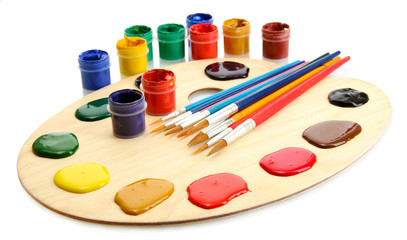 wooden art palette with  paint and brushes.isolated on white