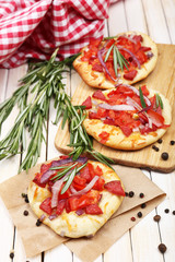 Small pizzas on baking paper close up