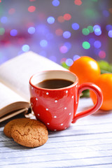 Composition of book with cup of coffee and Christmas