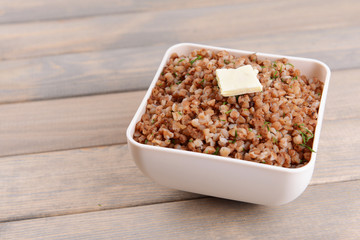 Boiled buckwheat in bowl on table close-up
