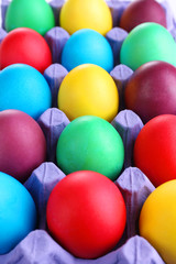 Fototapeta na wymiar Colorful Easter eggs in tray close up