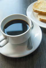 Coffee and  toast on wooden table