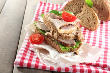 Delicious sandwiches with meet on table close-up