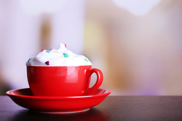 Cup of strong coffee with cream and candies