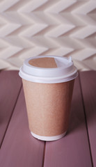 Cup of strong coffee on color wooden table, on light background