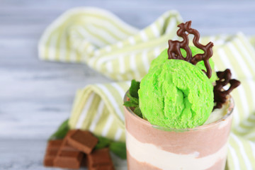 Tasty chocolate mousse with sorbet on wooden table