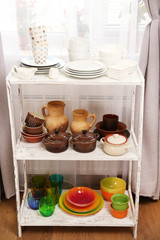 Different tableware on shelf in the interior