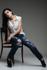 beautiful brunette, sitting on a brown wooden chair