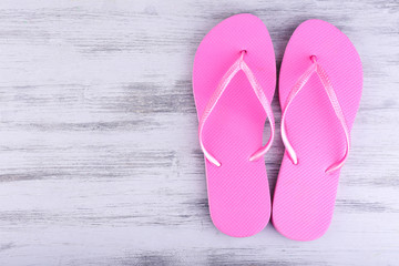 Bright flip-flops on color wooden background