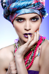 beautiful girl in a head-dress from the coloured fabric, glamour