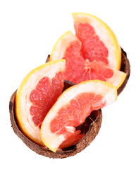 Grapefruit slices in coconut shell isolated on white