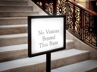 Close-up of a signboard with the message "No Visitors Beyond Thi