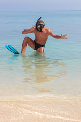 Funny scuba diver at the beach