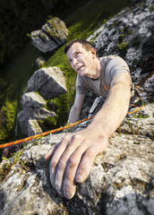 Man climbing limestone wall, Poland.