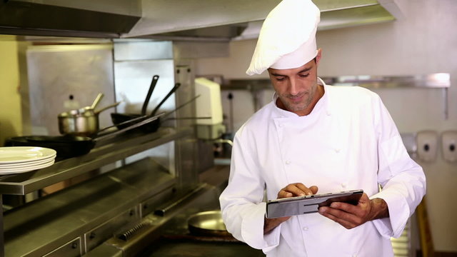 Handsome chef using tablet pc