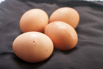 raw eggs close up on black background