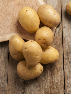 Potatoes close up on wooden background