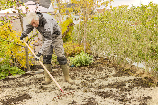 Gardener Raking Soil