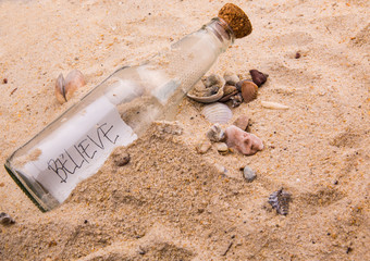 Concept image of a message BELIEVE in a bottle