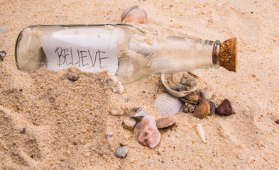 Concept image of a message BELIEVE in a bottle