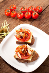 bread seasoned with oil and sliced tomatoes on a table