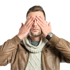Men covering his eyes over white background