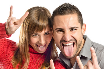 Couple doing the horn sign over white background