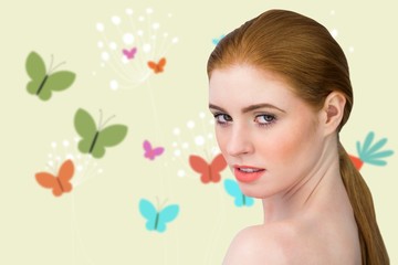 Obraz na płótnie Canvas Composite image of beautiful redhead looking at camera