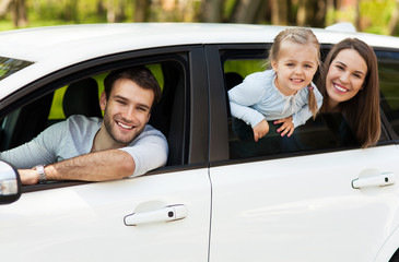 Family sitting in the car looking out windows