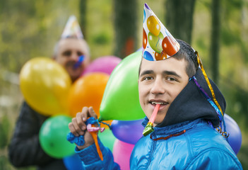 Boy with balloons in birthday party at outdoors