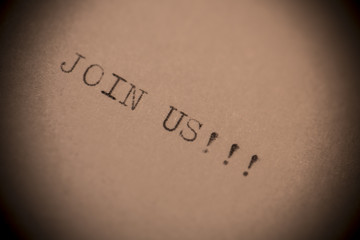 old typewriter with text join us