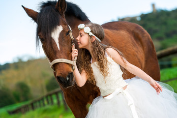 Girl giving horse a kiss