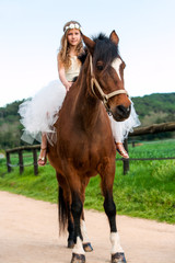 Fototapeta premium Girl riding brown horse.