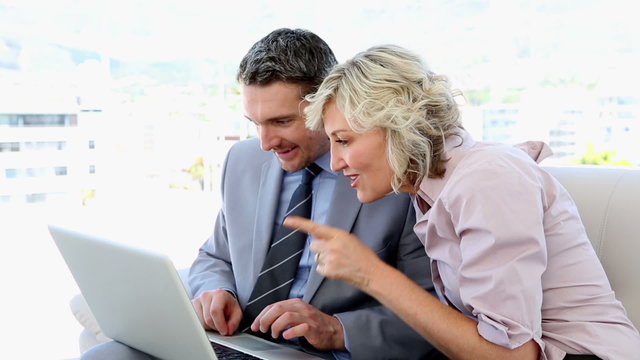 Business people working together on laptop