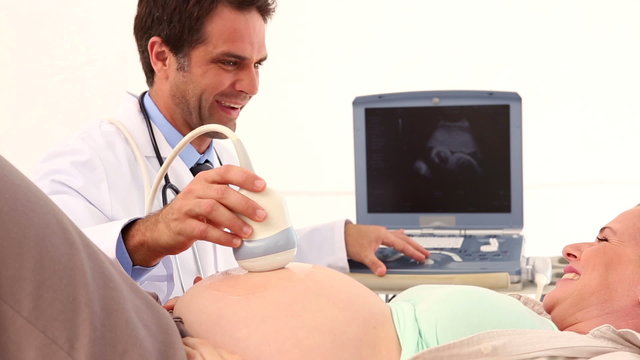 Pregnant woman having a sonagram scan