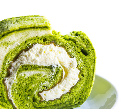 Green tea roll cake on white background