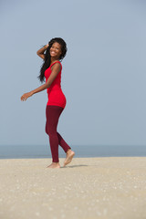 African american woman walking on the beach