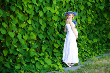 Fototapeta premium Pregnant caucasian woman takes rest outdoor