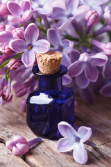 Extract from the fragrant lilac flowers close up on the table